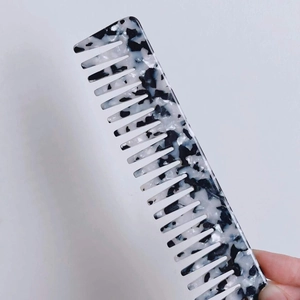 Wide tooth acetate hair comb with marble pattern for detangling and styling