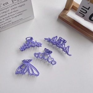 Set of four matte purple hair clips in butterfly, star, heart, and abstract shapes