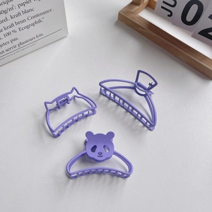 Three purple matte claw clips in panda, cat ear and semicircular shapes for women