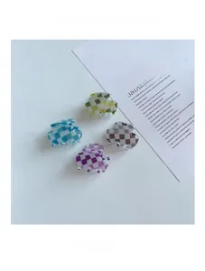 Détail de quatre mini pinces à cheveux à damier aux couleurs rétro de style français
