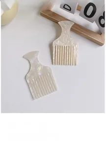 Detail of cellulose acetate hair combs with marble texture and pearlescent finish