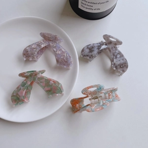 Set of four large acetate hair claws in leopard, marble, and floral prints