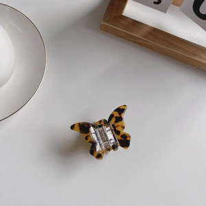 Close-up of tortoise shell pattern acetate butterfly hair claw with metal spring