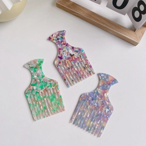 Three-piece acetate hair comb set with elegant colorful marble patterns on a white background