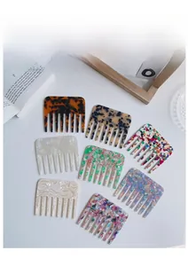 Detail of wide tooth acetate combs in various marble and tortoiseshell patterns