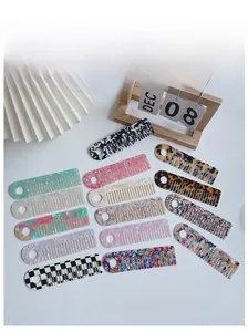 Flat lay of diverse acetate hair combs in marble and tortoiseshell patterns on white background