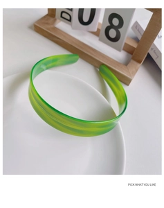 Detail of green marble acetate hair claw clip on a white ceramic plate setting