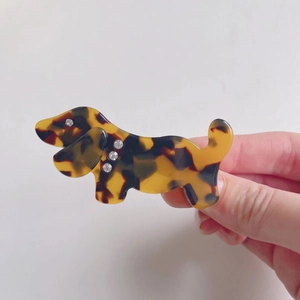 Handheld dachshund hair clip with tortoiseshell pattern and sparkling rhinestone accents