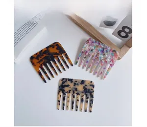 Chic cellulose acetate wide-tooth hair combs featuring marble and tortoiseshell patterns