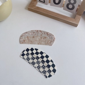 Chic acetate hair comb set in marble beige and checkerboard patterns with crescent shape
