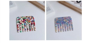 Detail of wide-tooth acetate hair combs in colorful mosaic and purple marble patterns