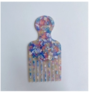 Detail view of colorful marble acetate wide-tooth comb for detangling curly hair