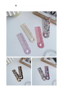 Macro detail of anti-static acetate hair combs featuring marble patterns and wide teeth
