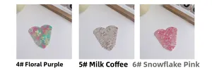 Detailed close-up of heart-shaped acetate hair combs in floral purple and milky coffee