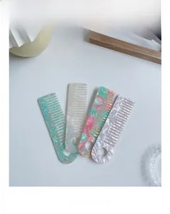 Detail of four acetate hair combs featuring colorful marble textures and pearlescent finish