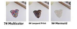 Detailed view of heart-shaped acetate hair combs in floral, leopard, and pearlescent finishes