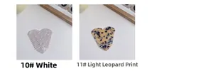 Macro shot of heart-shaped acetate hair combs in white marble and leopard patterns