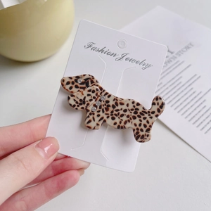 Chic acetate dachshund hair clip with leopard pattern and rhinestone collar on jewelry card