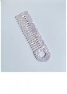 Detail of lavender marble acetate hair comb with wide teeth and a convenient hanging hole