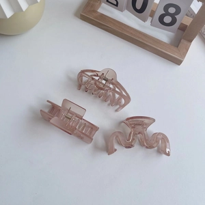 Three elegant translucent light purple hair claws in rectangular and wavy styles