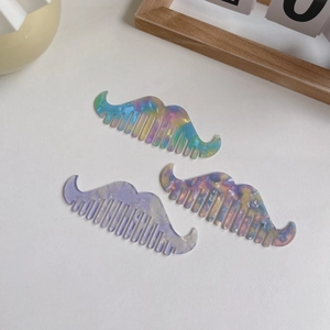 Three creative mustache shaped acetate combs with marble and colorful floral patterns