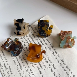 Group display of 5 mini acetate cat hair claws in tortoiseshell and marble patterns