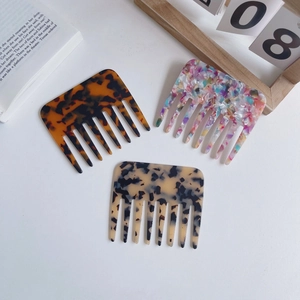 Three-piece set of acetate wide-tooth hair combs in tortoiseshell and marble patterns