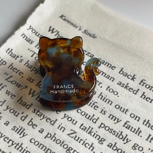 Macro shot of tortoiseshell cat-shaped hair claw clip with France Handmade lettering