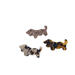 Three acetate dog hair clips with leopard, tortoiseshell, and cow patterns and rhinestones