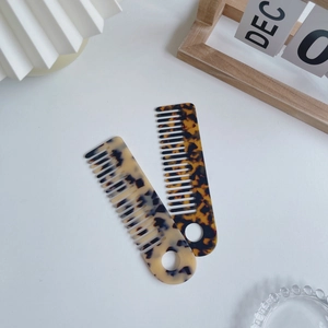 Elegant two-piece acetate hair comb set with marble texture and hanging hole design
