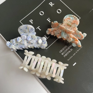 Floral acetate hair claw clips with rhinestones in light blue and orange floral patterns