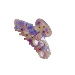 Floral acetic acid hair claw clip with purple rhinestones and marble texture on white background