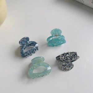 Set of four minimalist acetate hair claws with marble and tortoiseshell patterns