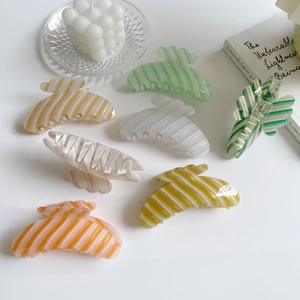 Colorful striped shark hair clips in assorted pastel colors for elegant hair styling