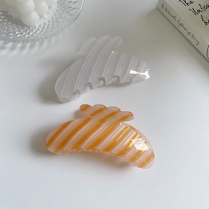 Minimalist pearlescent white and orange striped hair claws in acetate material