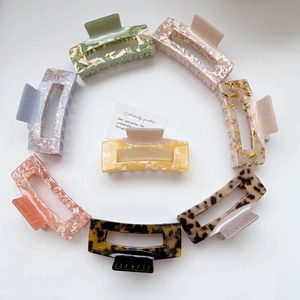 Collection of large square cutout acetate hair claws in various marble and tortoiseshell patterns