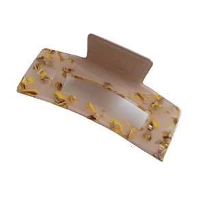 Rectangular acetate hair claw clip with yellow marble pattern on a white background