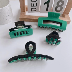 Set of 4 dark green and black acetate hair claws in various sizes and shapes