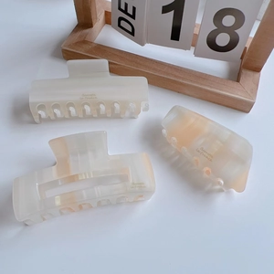 Set of orange and cream acetate hair claws with marble texture in elegant Korean design