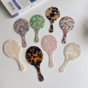 Portable acetate hand mirrors in various retro marble and tortoiseshell patterns
