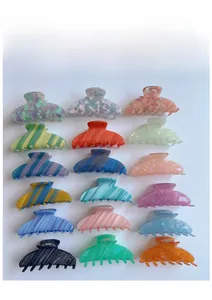 Multiple acetate hair claw clips in marble and striped patterns on white background