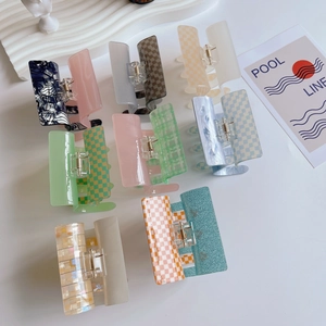 Checkerboard pattern cellulose acetate hair claws set in various colors and designs