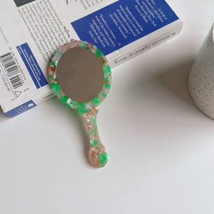 Vintage tortoiseshell acetate handheld makeup mirror with green marble finish and wavy edge