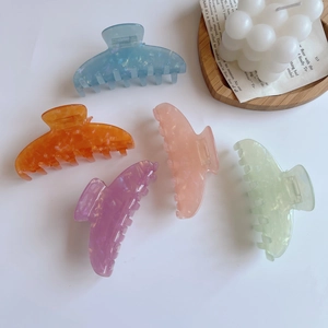 Flat lay of acetate hair claws in pastel marble colors with gold flakes detail