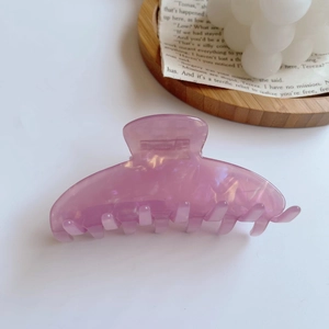 Close-up of purple acetic acid hair claw clip with marble texture and glossy finish