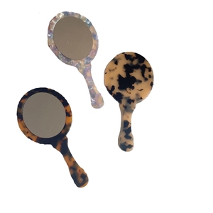 Vintage acetate portable handheld mirrors in tortoiseshell, yellow spotted and pearl patterns