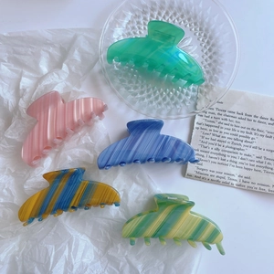 Set of 5 large acetate claw clips in pastel and marbled colors on white paper