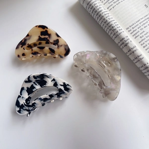 Detailed set of three elegant acetate claw clips in marble and tortoiseshell finishes