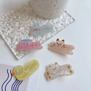 Close-up of five colorful acetate animal hair clips in cute rabbit and bear designs