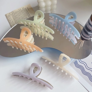Vue détaillée de grandes pinces à cheveux en acétate aux cinq couleurs douces de macaron